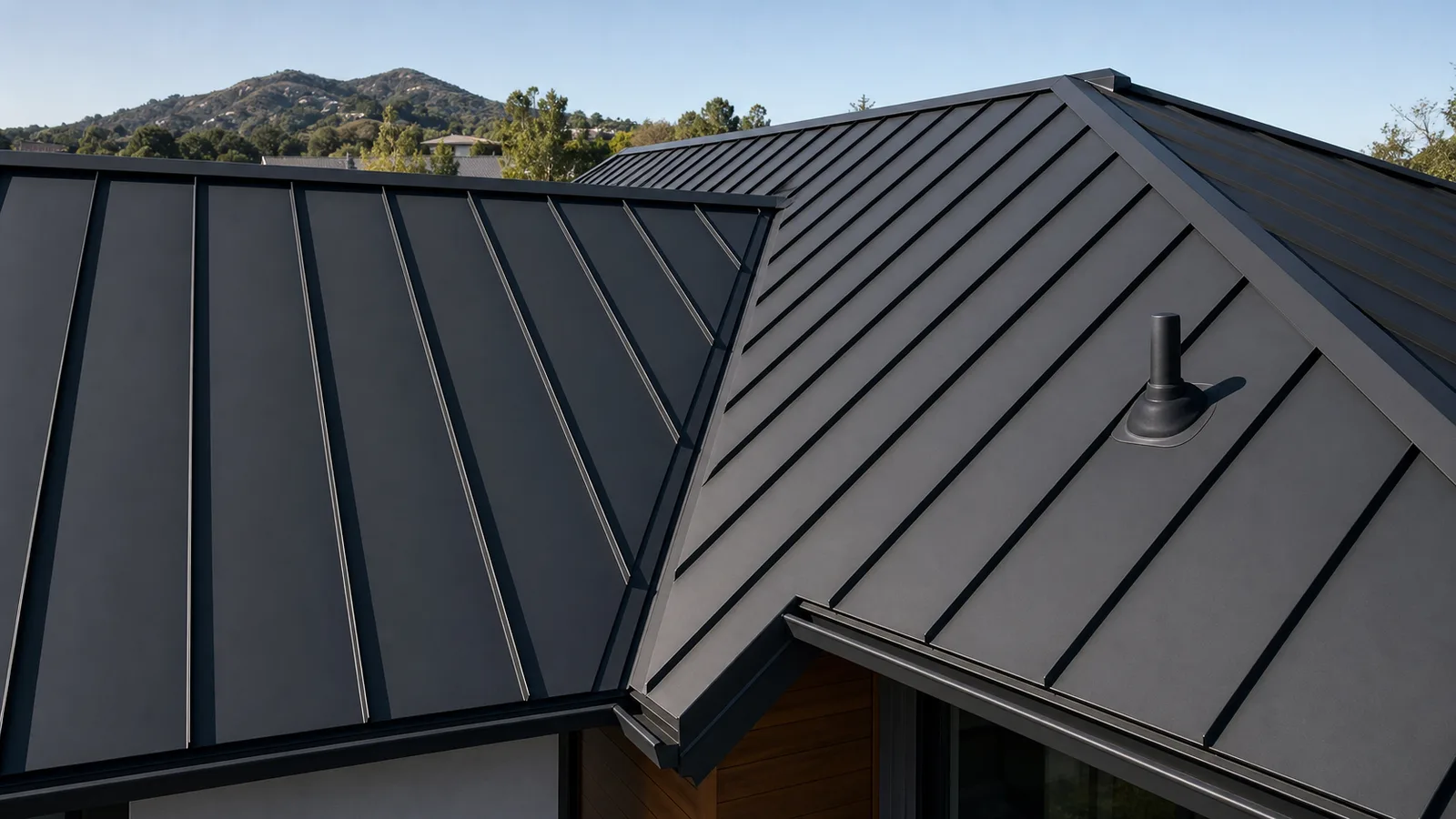 Charcoal standing-seam metal roof with concealed seams, valley, ridge and pipe boot