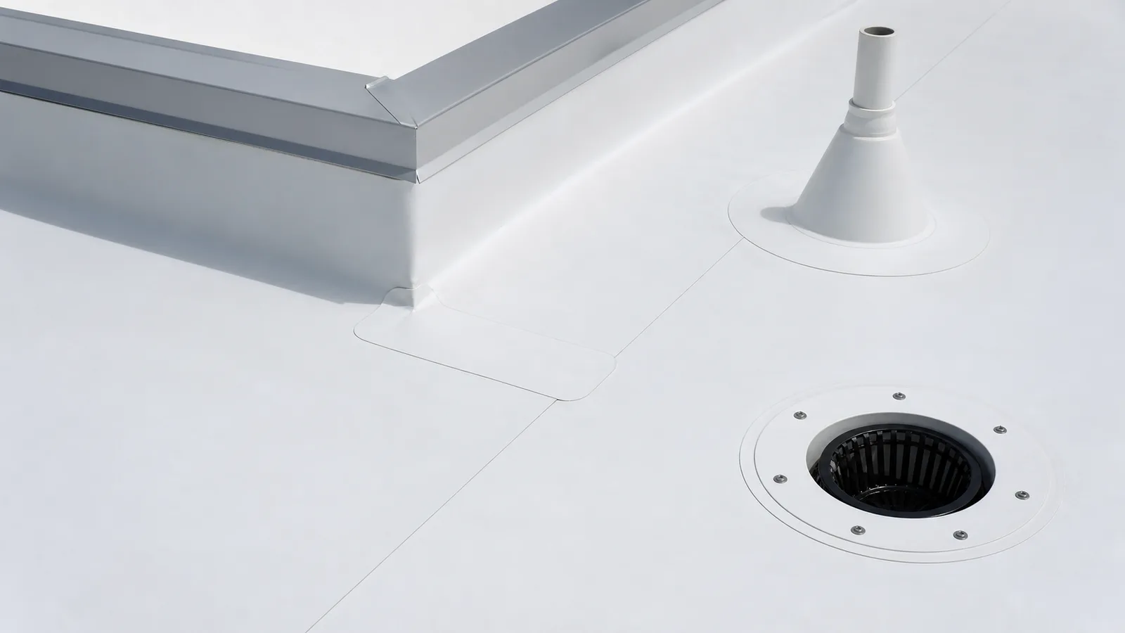 White TPO roof with welded seams, curb corner, pipe boot and internal drain