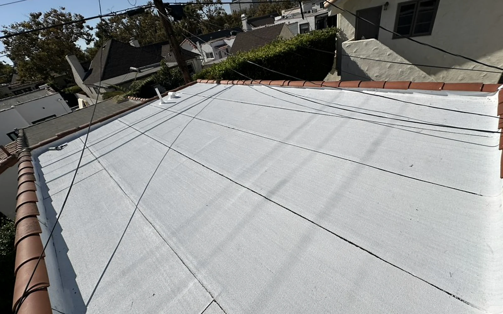Completed Poly Fresko cool-roof surface on a Beverly Hills low-slope project documented by Sky Shield Roofing