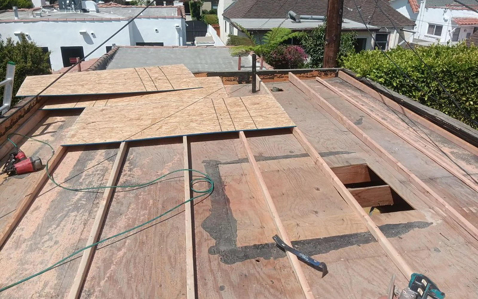 Framed drainage cricket during a documented Beverly Hills low-slope roof correction