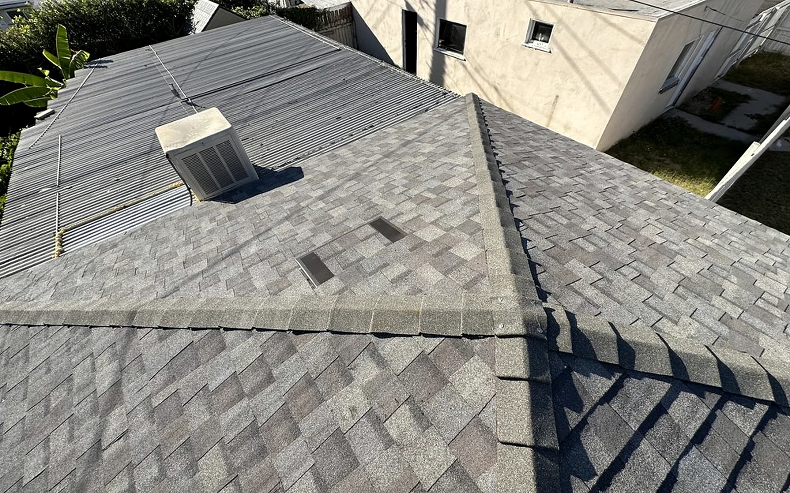 Completed shingle roof showing ridges, penetrations and transitions for condition review