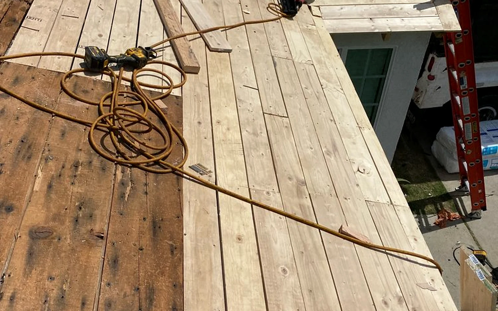 Deck replacement after severe wood damage from a documented roof leak