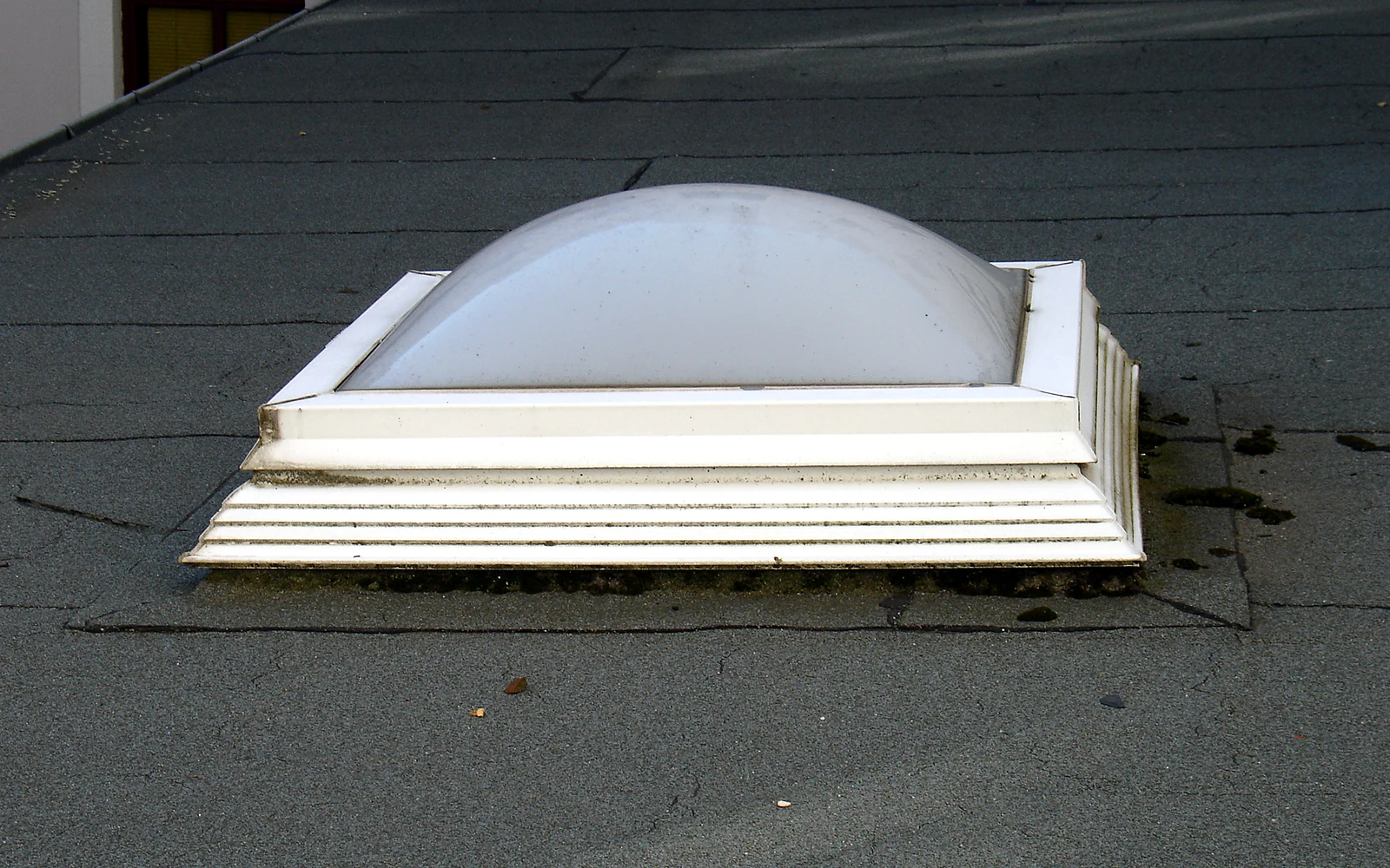 Real curb-mounted dome skylight on a low-slope roof