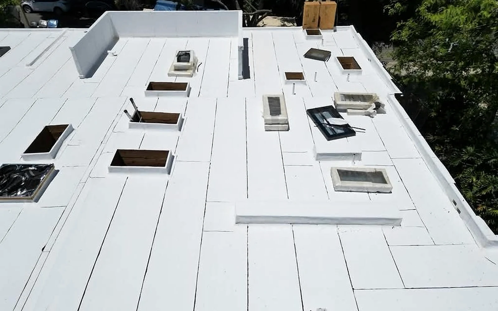 Documented low-slope roof openings prepared for new skylight units